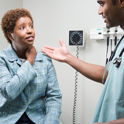 African American woman getting a check up... again | Shutterstock, XiXinXing