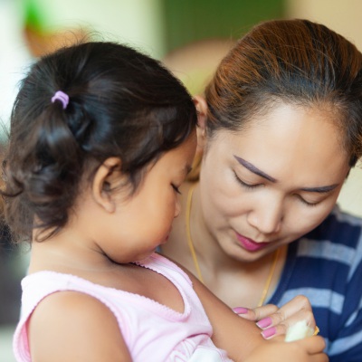 Concerned Asian mom and daughter | Shutterstock, JamieSit