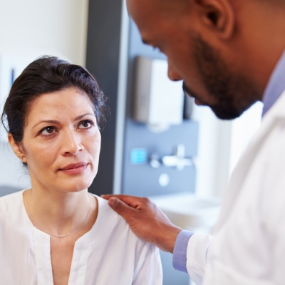 Concerned woman with doctor | Shutterstock, Monkey Business Images