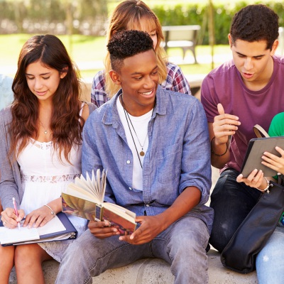 Diverse group of students sitting together, Shutterstock | Monkey Business Images