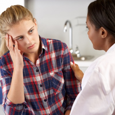 Doctor consulting with patient | Shutterstock, MonkeyBusinessImages