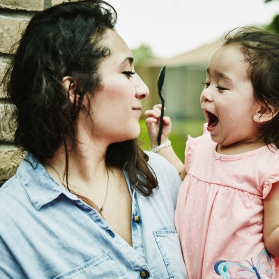 Excited Latina Girl and Mom | Getty Images