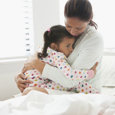 Hispanic Mom Comforting Daughter | Getty Images | Jose Luis Pelaez