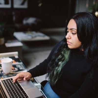 Latina at computer, Getty Images | LeChatNoir