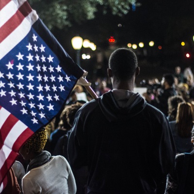 Man holding flag at rally | Getty Images