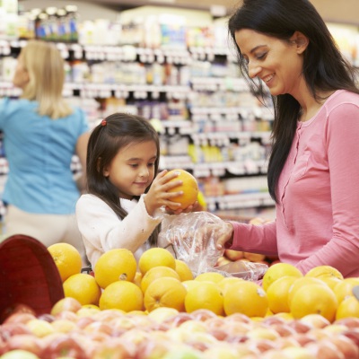 Mother and daughter buying fruit at store, Shutterstock, Monkey Business Images