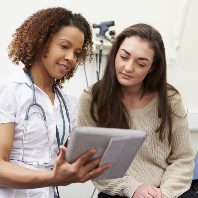 Nurse showing results | Shutterstock, Monkey Business Images