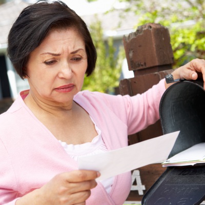 Older woman concerned about bills | Shutterstock, Monkey Business Images