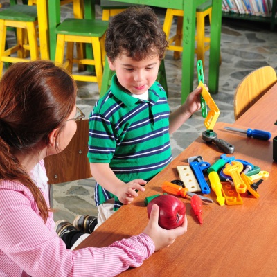 Preschool Instructor With Young Child | Shutterstock, Lusia Leal Photography