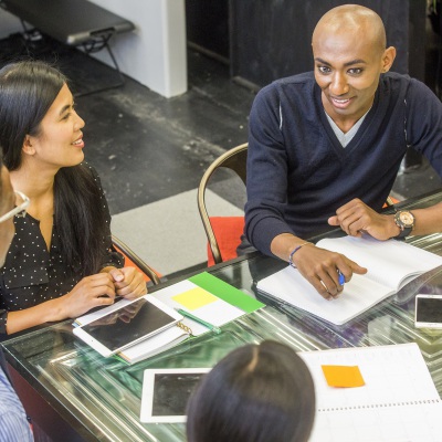 Smiling People in a Meeting | Getty Images