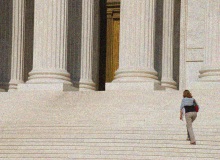 Woman walking up courthouse steps | Getty Images, Joel Carillet