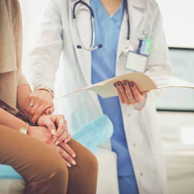 Woman with concerned doctor | Shutterstock, S_L