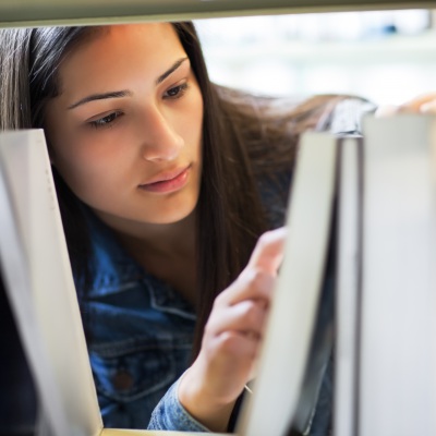 Young Hispanic Student at Library Shutterstock|Arek Malang