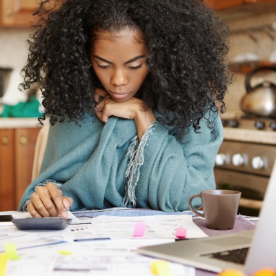 Youngwomanstressedoverfinances | Shutterstock, WAYHOME studio