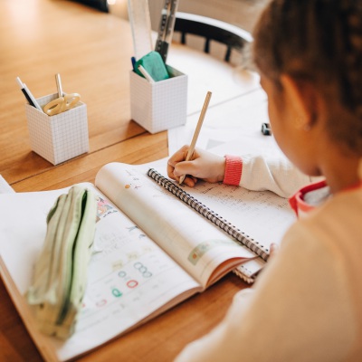 Child doing homework at home | Masko | Getty Images