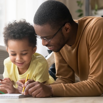 dad and child drawing at home_fizkes_Getty Images