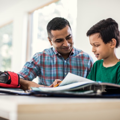 Father and son doing homework | Getty Images