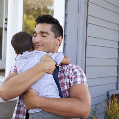 father hugging son | Shutterstock, Monkey Business Images