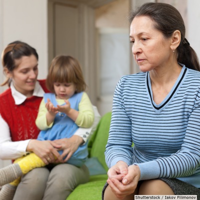 Pensive woman with daughter and grandchild | Shutterstock, Iakov Filimonov