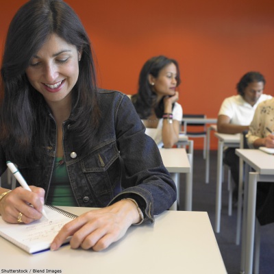 Adult woman in classroom | Shutterstock, Blend Images