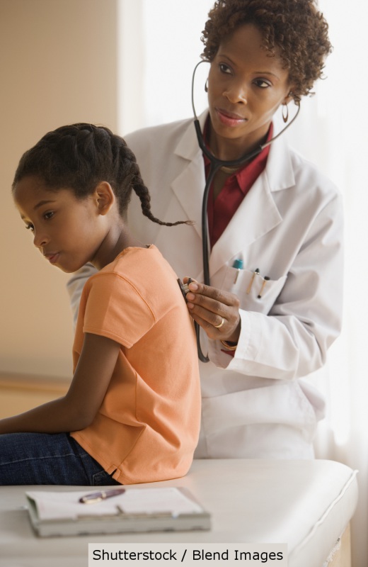 African American child getting a check up | Shutterstock, Blend Images