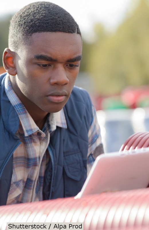 Young man studying tablet at work site | Shutterstock, Alpa Prod