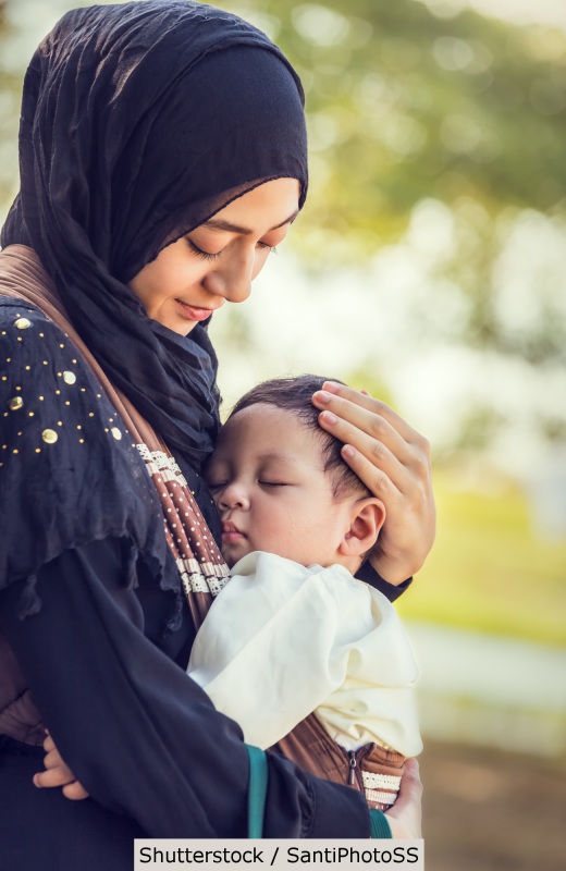 Muslim woman holding baby | Shutterstock, SantiPhotoSS