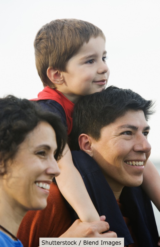 Parents carry happy child | Shutterstock, Blend Images