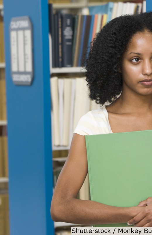Young African American woman at library | Shutterstock, Monkey Business Images