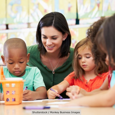 Pre-K children with their teacher | Shutterstock, Monkey Business Images