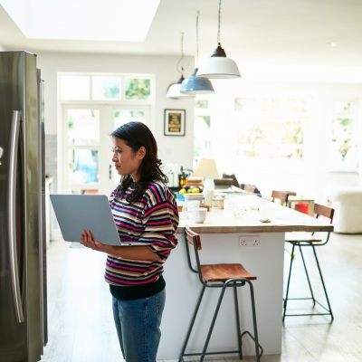 Woman with laptop at home | Getty Images