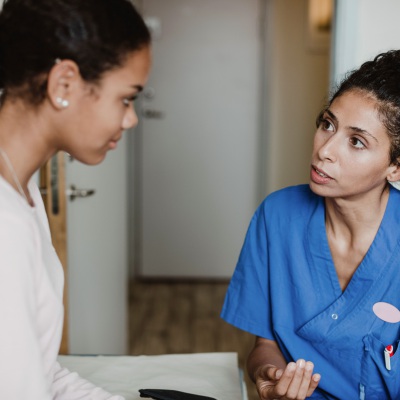 young woman of color at doctors appointment 