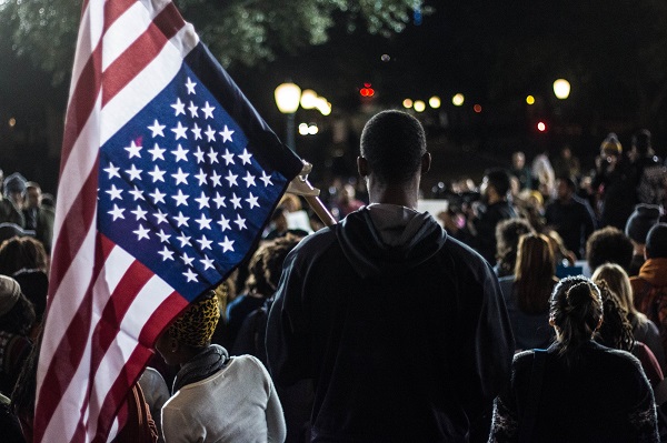 Man holding flag at rally | Getty Images