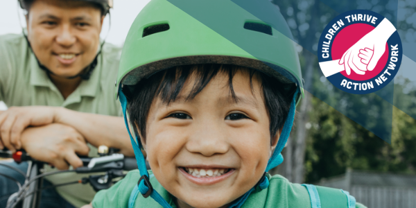 Child smiles while wearing a helmet