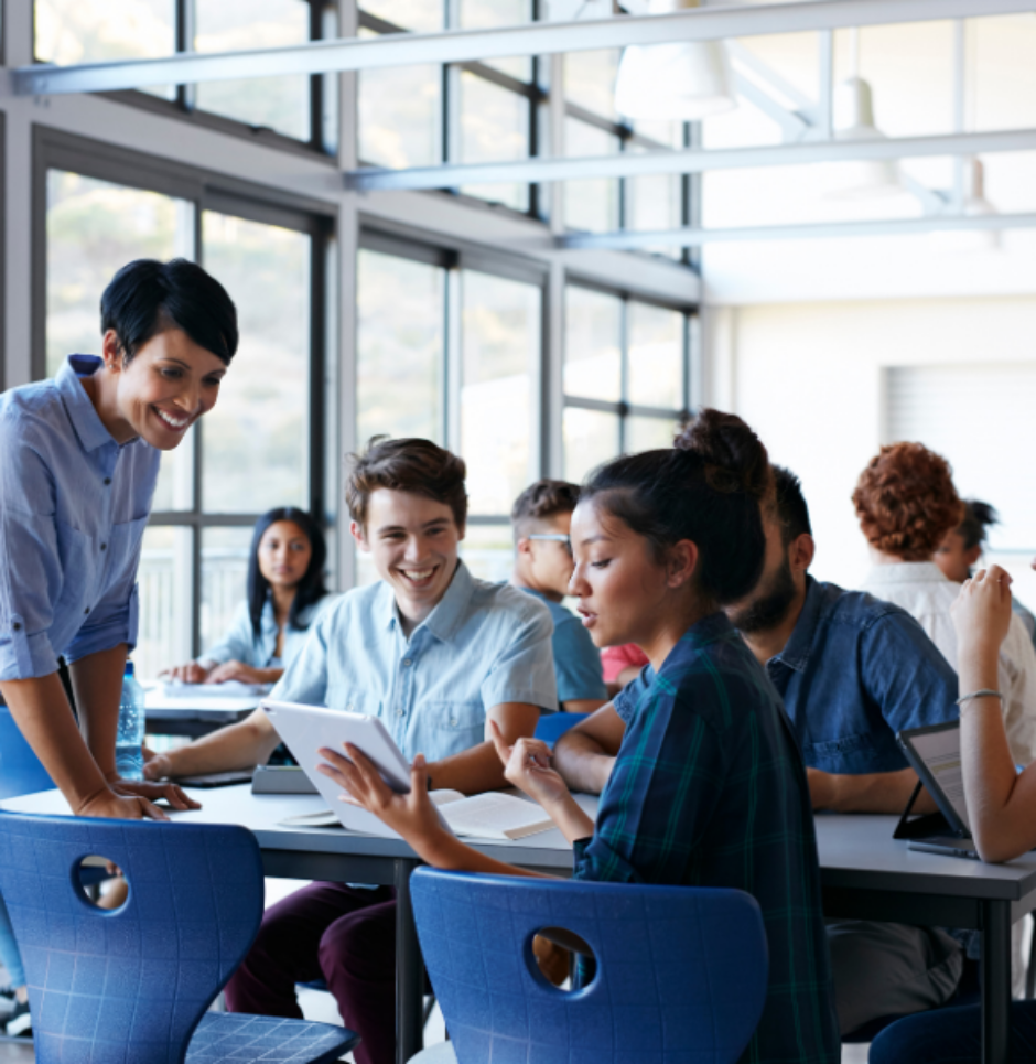 Teacher assisting group of students in classroom