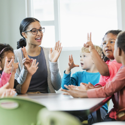 Multi-ethnic preschool teacher and students in classroom
