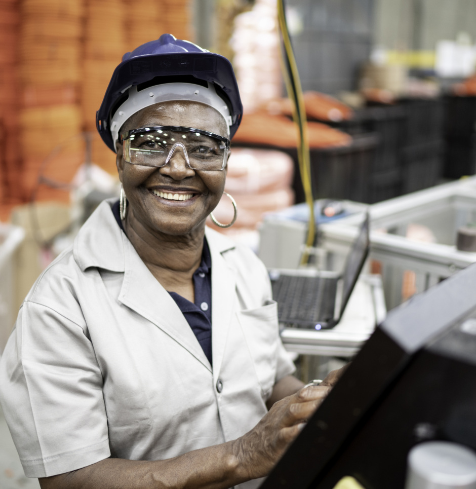 Senior woman working in a factory portrait as a cover of a report that focuses on equity in infrastructure investments.
