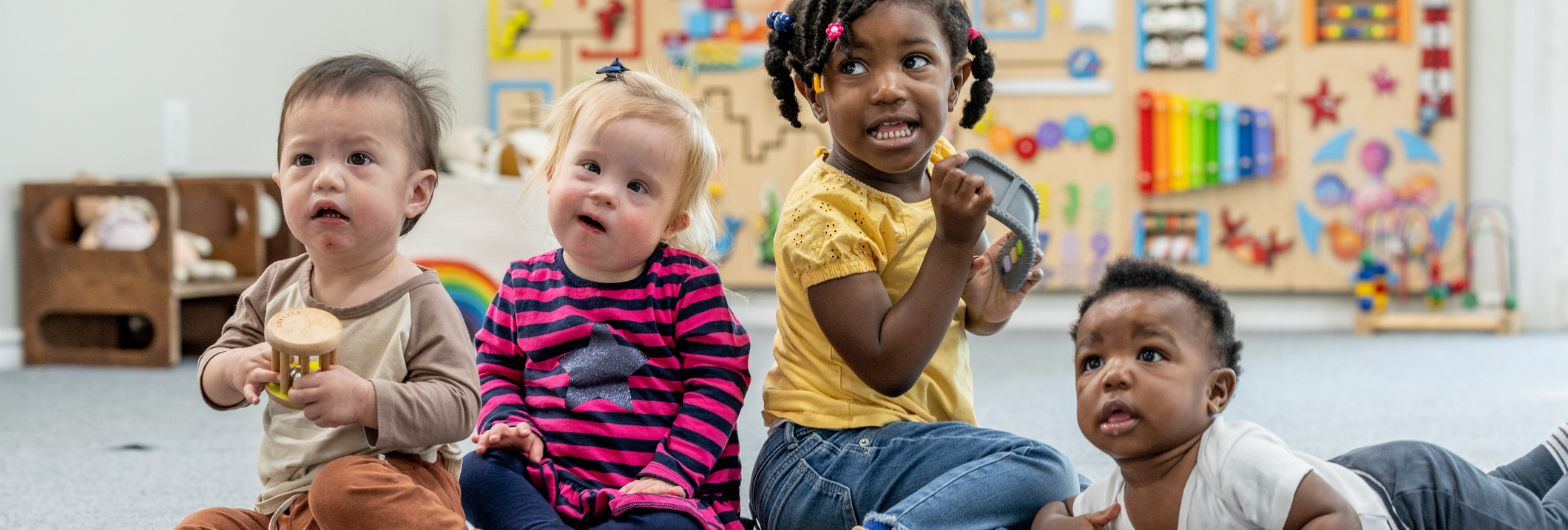 toddlers playing in day care child care early head start looking into the distance. Banner photo for new head start final rule blog at CLASP.ORG