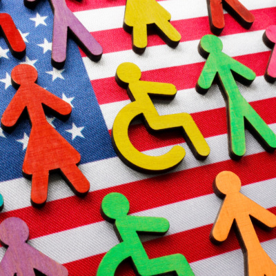symbols of diverse people in front of a flag of the united states of america.